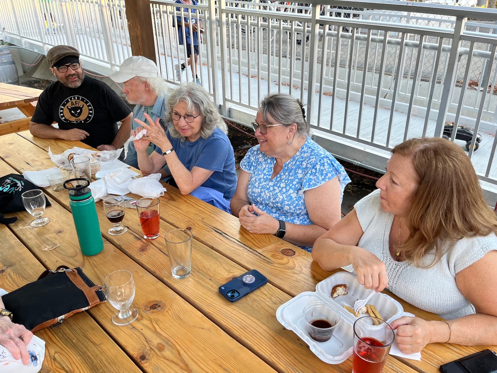 Robin Cole in conversation with community members at an outdoor gathering